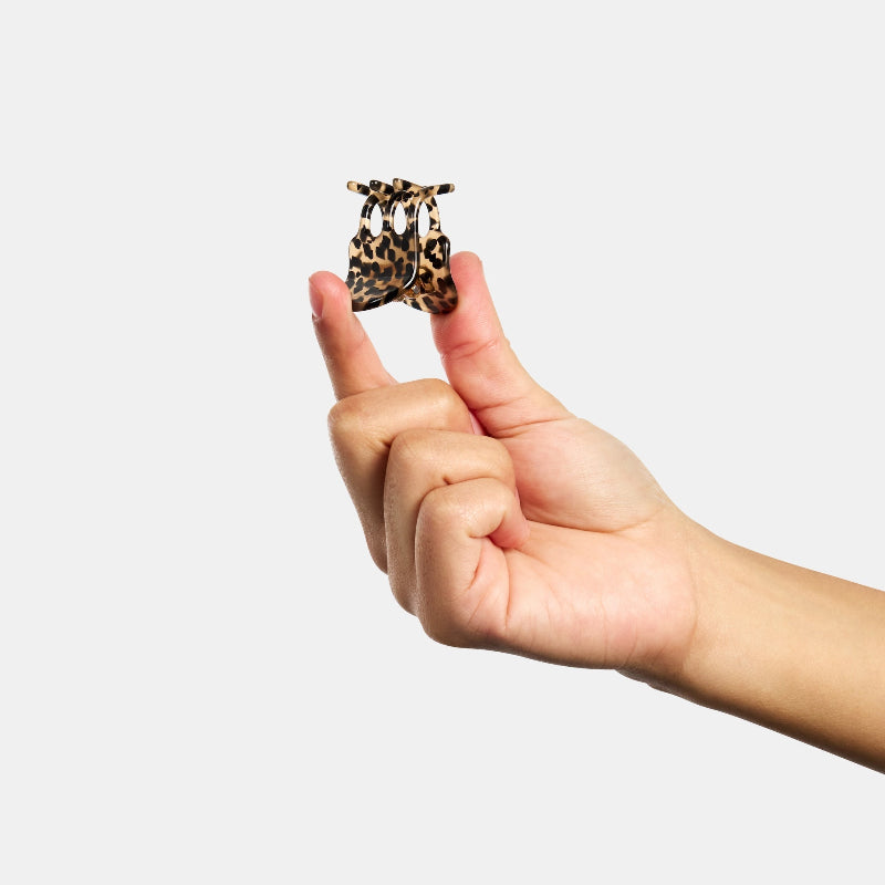 Hand holding up Chunks Mini Claw Clip in Cougar on a white background