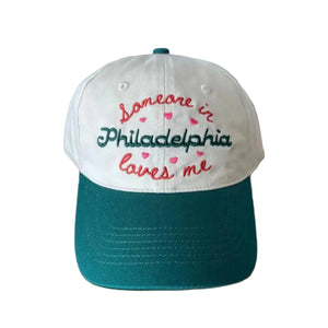 Embroidered Baseball Hat that says Someone in Philadelphia Loves Me With Hearts on a cream and green hat