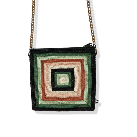 A green, beige, and multicolored geometric patterned crossbody bag.