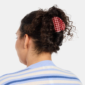Woman with thick curly hair wearing the Chunks Juno Hair Claw Clip in Red Plaid 