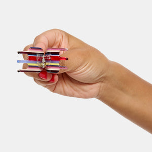Hand holding Chunks Mini Claw in Charlotte open on a white background