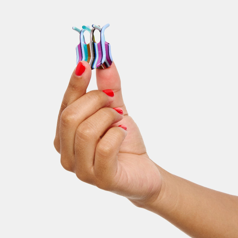 Hand holding Mini Hair Claw Clip in Frances on a white background